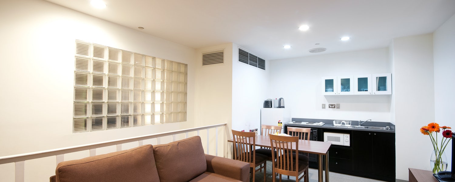 An apartment in a melbourne hotel with lounge and kitchen